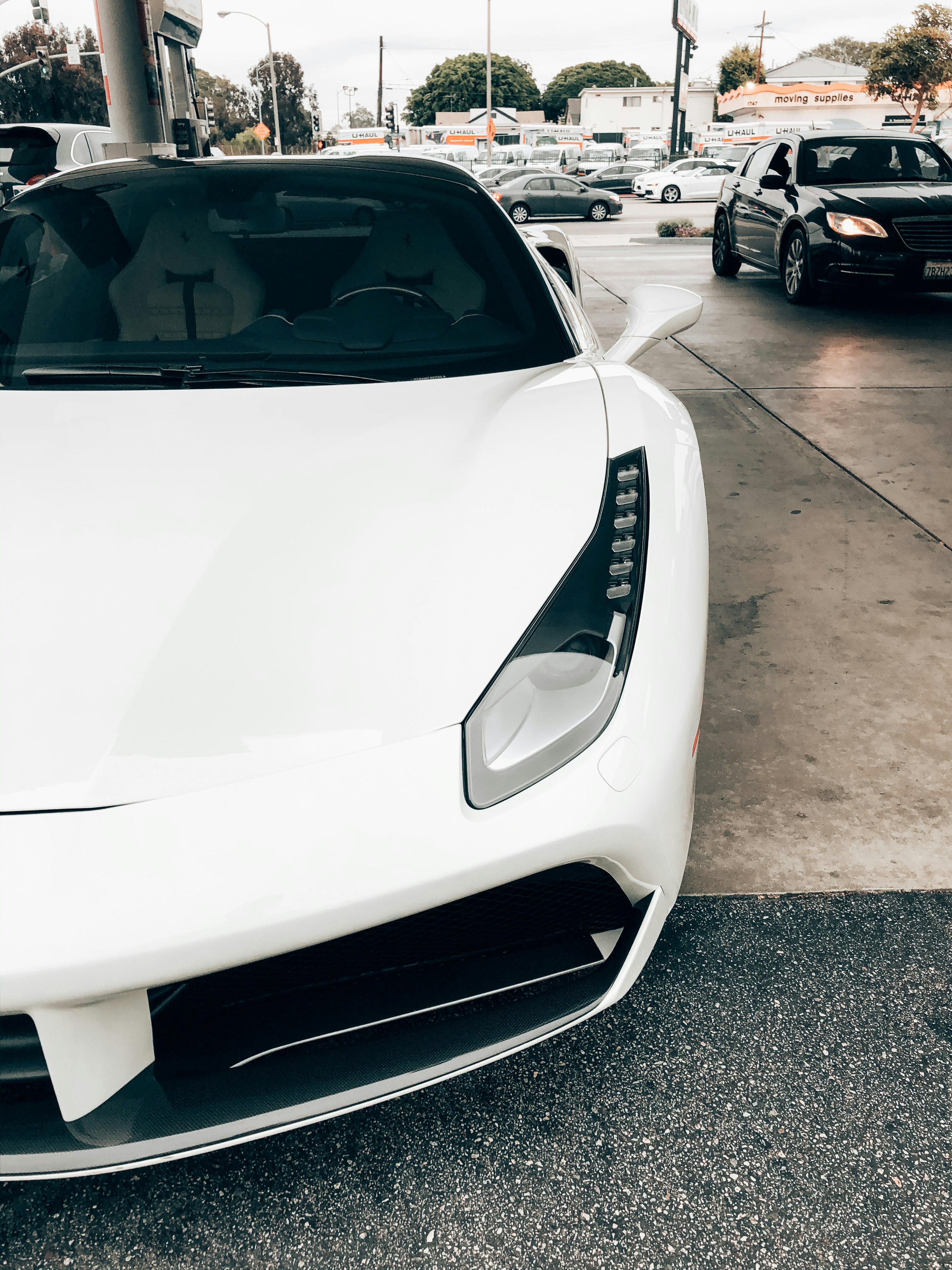 white porsche 911 parked on parking lot during daytime